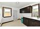 Convenient laundry room with tile floors, sink, and storage cabinetry at 9080 W Forest Dr, Elwood, IN 46036