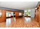Spacious living room featuring wood-paneled walls, hardwood flooring, and ample natural light at 9080 W Forest Dr, Elwood, IN 46036