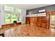 Bright living room with hardwood floors, lots of natural light and wood paneling at 9080 W Forest Dr, Elwood, IN 46036