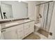 Bathroom featuring double sinks, mirrors, and a shower-tub combo with a decorative shower curtain at 9640 Katana Cir, Fishers, IN 46040