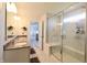 Modern bathroom featuring double sinks, a luxurious shower with glass enclosure, and elegant fixtures at 9640 Katana Cir, Fishers, IN 46040