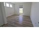 Bright bedroom with light-colored laminate flooring and natural light pouring in through the large windows at 9640 Katana Cir, Fishers, IN 46040