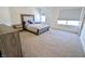 Cozy bedroom with plush carpet, a comfortable bed, and natural light from two windows at 9640 Katana Cir, Fishers, IN 46040