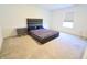 A bedroom with a large window and carpet with a bed and matching bedside table at 9640 Katana Cir, Fishers, IN 46040