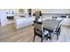 Open concept dining area featuring a dark wooden table and upholstered chairs with views of the kitchen at 9640 Katana Cir, Fishers, IN 46040