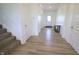 Bright entryway with hardwood floors, white trim, and staircase at 9640 Katana Cir, Fishers, IN 46040