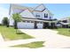 Beautifully landscaped home with a three-car garage, long driveway and sidewalk at 9640 Katana Cir, Fishers, IN 46040