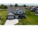Beautiful two-story home with a manicured lawn and attached three-car garage at 9640 Katana Cir, Fishers, IN 46040