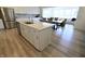 Open concept kitchen with island, stainless steel appliances, and views to the dining and living room at 9640 Katana Cir, Fishers, IN 46040