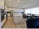 Open-concept kitchen with modern appliances, island, and dining area at 9640 Katana Cir, Fishers, IN 46040