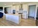 Modern kitchen with white cabinets, stainless steel appliances, and an island with countertop space and a sink at 9640 Katana Cir, Fishers, IN 46040