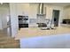 A modern kitchen features white cabinets, stainless steel appliances, and a large island with a white countertop at 9640 Katana Cir, Fishers, IN 46040