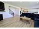 Open-concept living space featuring a staircase, fireplace and view to the kitchen at 9640 Katana Cir, Fishers, IN 46040