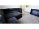 Spacious living room featuring plush carpet and a large sectional sofa perfect for relaxing and entertaining at 9640 Katana Cir, Fishers, IN 46040