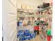 Walk-in pantry with abundant white shelving displaying canned goods, spices, and clear plastic storage containers at 9640 Katana Cir, Fishers, IN 46040