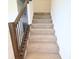 Carpeted staircase with wooden handrail and black iron balusters leading to the upper level of the home at 9640 Katana Cir, Fishers, IN 46040