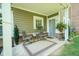 Back patio featuring an outdoor rug, two chairs, a table, and beautiful greenery at 9743 Herons Cv, Carmel, IN 46280