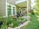 Back patio featuring an outdoor rug, two chairs, a table, and beautiful landscaping at 9743 Herons Cv, Carmel, IN 46280