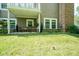 Backyard featuring a covered patio, green grass, and beautiful landscaping at 9743 Herons Cv, Carmel, IN 46280