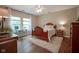 Bright bedroom with a wooden bed frame, ceiling fan, and lots of natural light at 9743 Herons Cv, Carmel, IN 46280