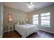 Light and airy bedroom with two windows, a white metal bed frame, and dark hardwood floors at 9743 Herons Cv, Carmel, IN 46280