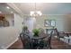 Cozy dining area with a round table and elegant chandelier, perfect for enjoying meals with Gathering and friends at 9743 Herons Cv, Carmel, IN 46280