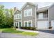 Charming two-story condo featuring neutral siding, white trim, a private balcony, and an attached one-car garage at 9743 Herons Cv, Carmel, IN 46280