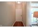 Neutral hallway with hardwood floors, leading to a well-lit and welcoming entrance that complements any decor style at 9743 Herons Cv, Carmel, IN 46280