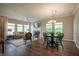 Open concept living space with dining area seamlessly flowing into the living room with a fireplace and large windows at 9743 Herons Cv, Carmel, IN 46280