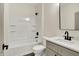 Bathroom has a shower/tub combo with storage, plus a gray vanity with black hardware at 9811 Warren Pl, Indianapolis, IN 46229