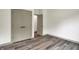 Bright bedroom with a large closet has sleek laminate flooring, and neutral paint at 9811 Warren Pl, Indianapolis, IN 46229