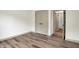 Bright bedroom with a large closet has sleek laminate flooring, and neutral paint at 9811 Warren Pl, Indianapolis, IN 46229