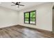 Bedroom with hardwood flooring, a ceiling fan and a large window to view the outside at 9811 Warren Pl, Indianapolis, IN 46229