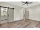 Bright bedroom features hardwood flooring, a ceiling fan and a bathroom at 9811 Warren Pl, Indianapolis, IN 46229