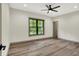 Bedroom with hardwood flooring, a ceiling fan and a great view of the outdoors at 9811 Warren Pl, Indianapolis, IN 46229