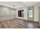 Light-filled dining area featuring hardwood floors and stylish lighting fixtures, ideal for entertaining at 9811 Warren Pl, Indianapolis, IN 46229