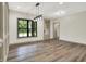 Light-filled dining area featuring hardwood floors and stylish lighting fixtures at 9811 Warren Pl, Indianapolis, IN 46229
