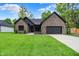 Charming brick home with a well-manicured lawn and a two-car garage, providing comfort and curb appeal at 9811 Warren Pl, Indianapolis, IN 46229