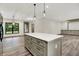 Open kitchen featuring white quartz island, stainless appliances, and hardwood floors, perfect for cooking at 9811 Warren Pl, Indianapolis, IN 46229