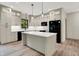 Modern kitchen with island, granite countertops, and stainless steel appliances, a culinary delight at 9811 Warren Pl, Indianapolis, IN 46229