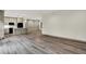 Bright living room showing a spacious area, hardwood floors, and a combined kitchen and eating area at 9811 Warren Pl, Indianapolis, IN 46229