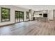 Open living room features hardwood floors, large windows, and flows to a kitchen with modern appliances at 9811 Warren Pl, Indianapolis, IN 46229