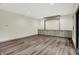 A spacious living room features hardwood flooring and custom built in cabinetry at 9811 Warren Pl, Indianapolis, IN 46229