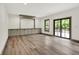 Spacious room with hardwood flooring, slider to the outside and custom built in cabinetry at 9811 Warren Pl, Indianapolis, IN 46229