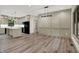 Open-concept living space with hardwood floors, connecting kitchen and dining areas, great for gatherings at 9811 Warren Pl, Indianapolis, IN 46229