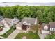 Aerial view of a beautiful home with mature trees, manicured lawn, and an inviting driveway in a lush neighborhood at 10243 Brixton Ln, Fishers, IN 46037