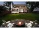 Home's backyard with a fire pit, chairs, and plenty of space for outdoor enjoyment at 10243 Brixton Ln, Fishers, IN 46037