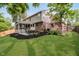 Spacious backyard featuring a patio with grill, screened-in porch, and landscaped garden, perfect for outdoor enjoyment at 10243 Brixton Ln, Fishers, IN 46037
