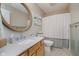 Bright bathroom features a neutral color palette, decorative mirror, and shower-tub combination at 10243 Brixton Ln, Fishers, IN 46037