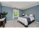 A comfortable bedroom with carpet features crown molding and soft blue walls at 10243 Brixton Ln, Fishers, IN 46037